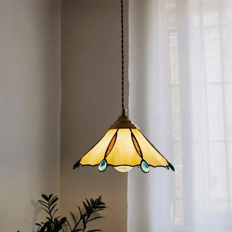 Yellow stained glass led pendant light with teal accents and brass finish for kitchen island decor