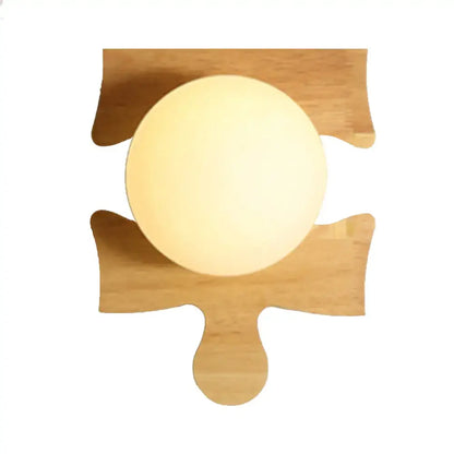 Warm softly glowing wall light with a beige wooden puzzle base mounted on a light bamboo wooden puzzle design