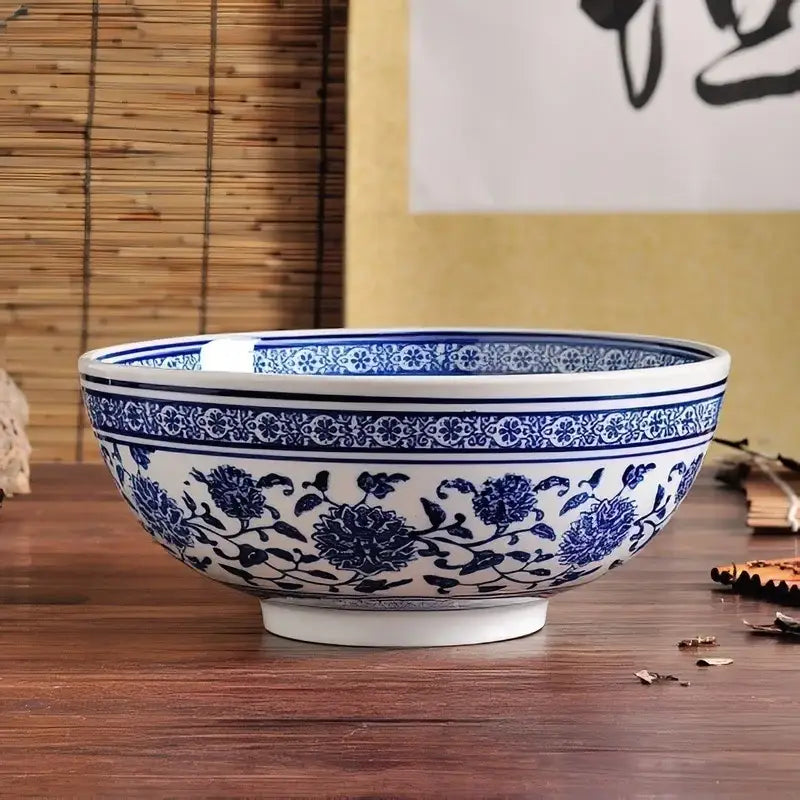 White ceramic noodle bowl with blue floral vine patterns and decorative bands in a japanese style dining set of 3