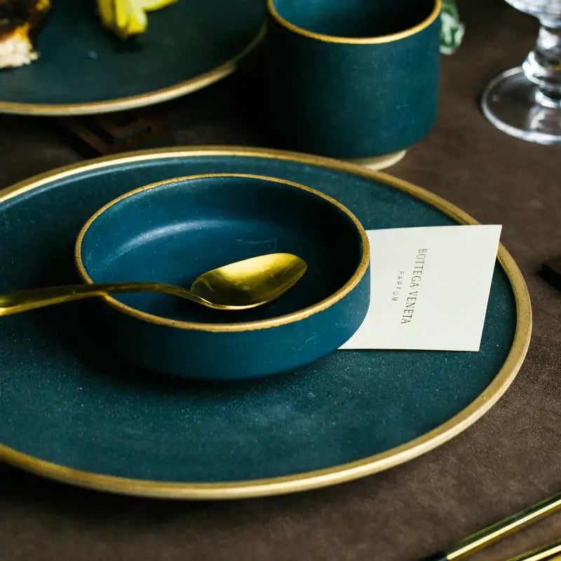 Deep teal ceramic dinner plate with gold rim and matching golden spoon from decorbites ceramic dinner set
