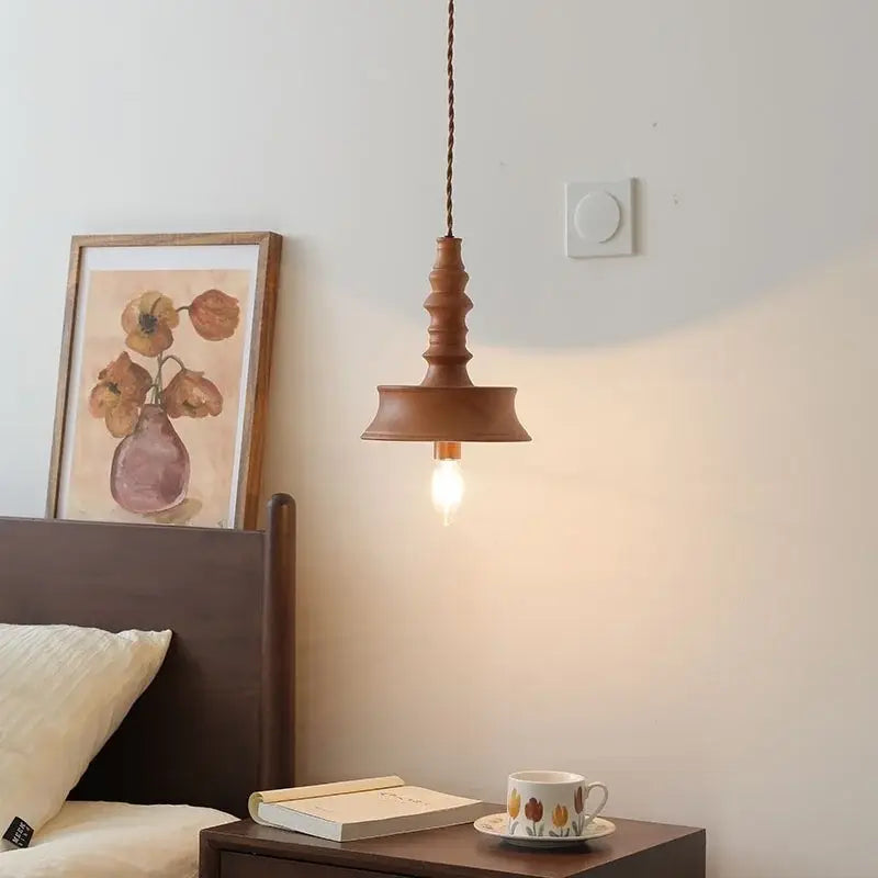 Warm-toned wooden japanese style pendant light with twisted cord suspension and exposed bulb for dining room decorbites japanese style