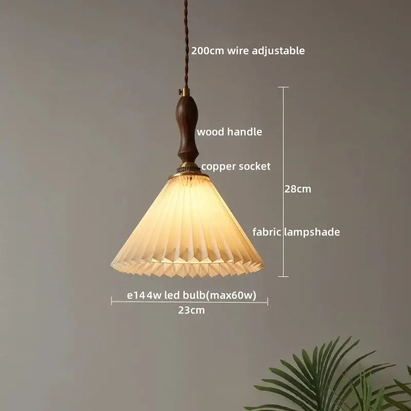 A warm-toned pleated fabric pendant lamp with wooden handle and copper socket in decorbites clear glass style