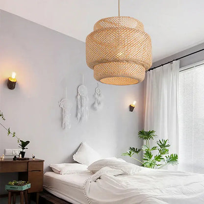 A japanese tiered bamboo pendant light with a natural beige hue and intricate lattice pattern for dining room focal point using natural materials