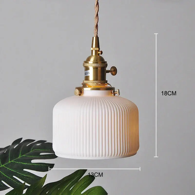 White ribbed glass pendant light with polished copper finish metal fixture for kitchen lighting