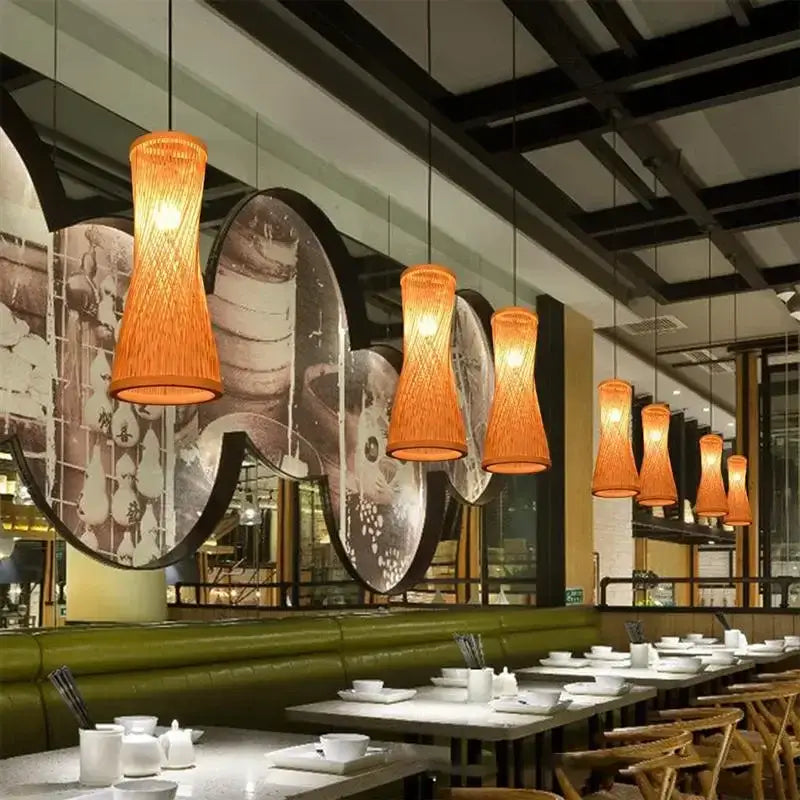 Warm orange woven pendant lights in natural finish made of Japanese bamboo hanging from the ceiling for dining room