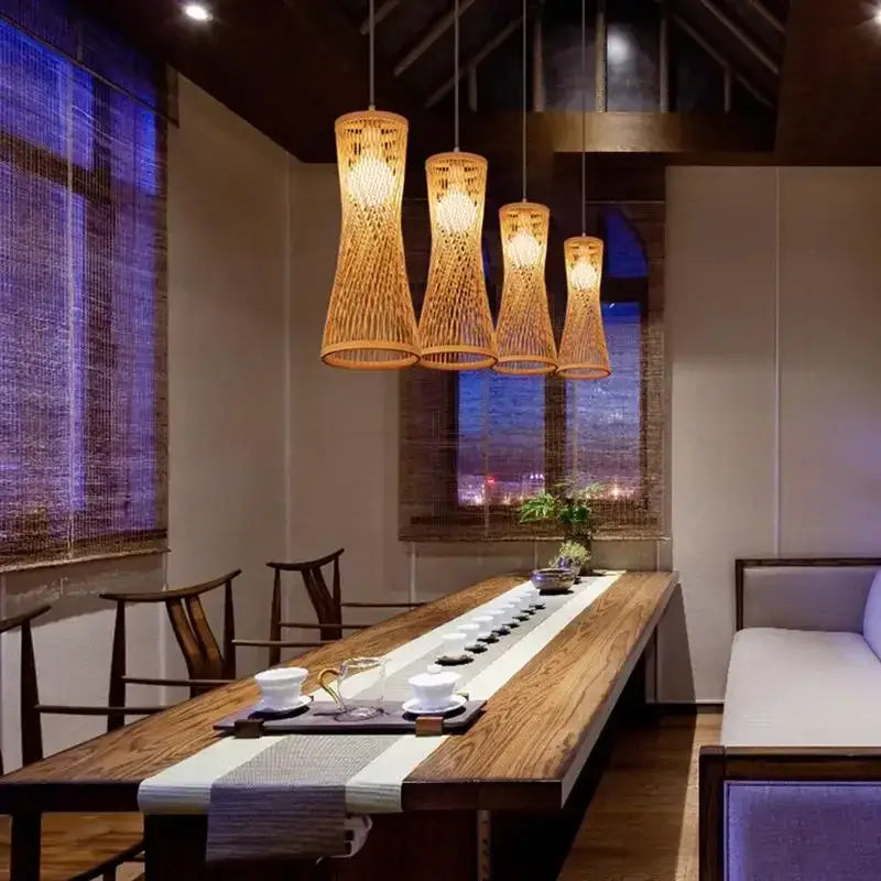 Four warm-toned woven pendant lights with natural finish in a modern rustic dining room setting