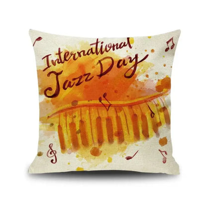 Square linen cushion cover featuring an orange and yellow letter notes piano graphic with international jazz day text decorbites