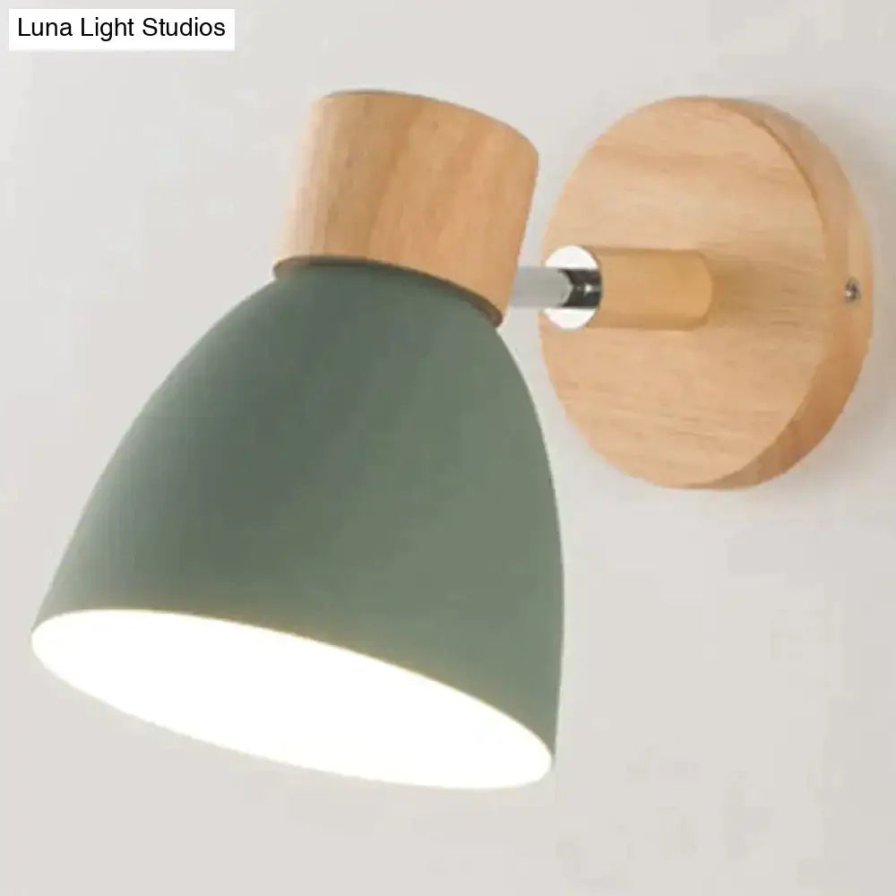 A modern joan wooden reading wall lamp with matte sage green shade and natural wood accents for bedroom lighting