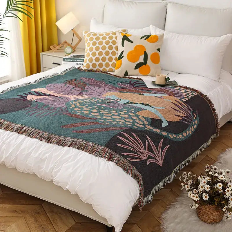 Cozy teal and black woven print throw blanket with vibrant tropical foliage and fringed edges decorbites leopard print