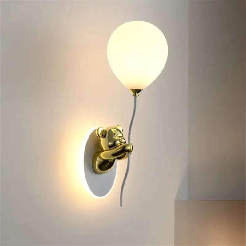 Kawaii gold bear balloon wall light features a gold-toned bear wall light holding a frosted balloon lampshade decorbites bear balloon