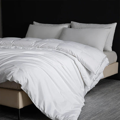King size white quilted goose down and silk duvet set with satin finish and subtle stitching for luxury bedroom use