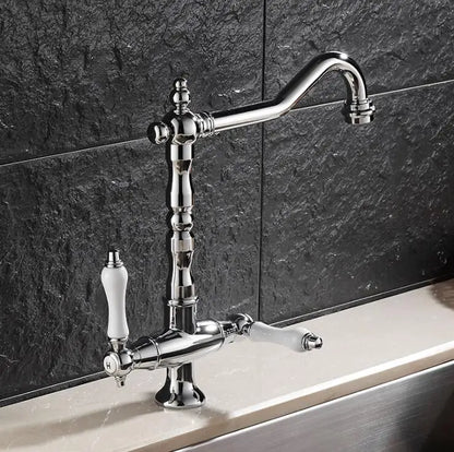 Chrome finished single hole kitchen faucet with elegant curved spout and ivory ceramic handles for hot and cold use
