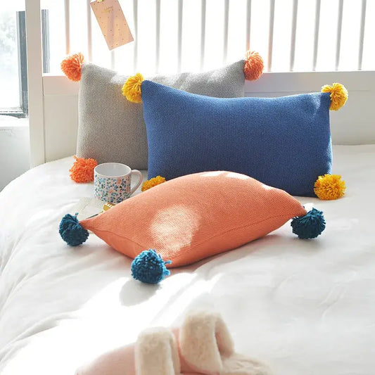 Set of three decorbites knit cushion covers in blue orange and grey with pom-pom accents for living room decor