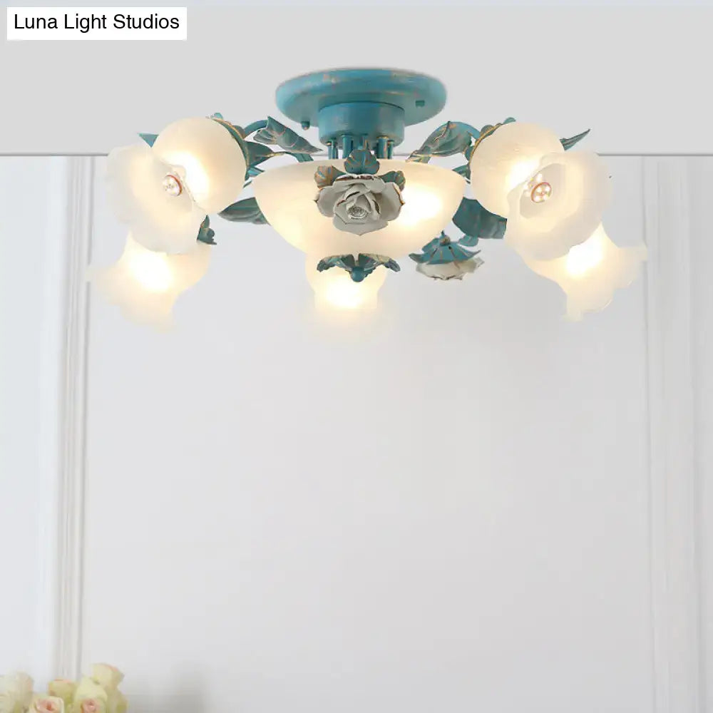 Teal-painted metal ceiling fixture with five frosted glass korean garden flower shades and central rose accent for bedroom