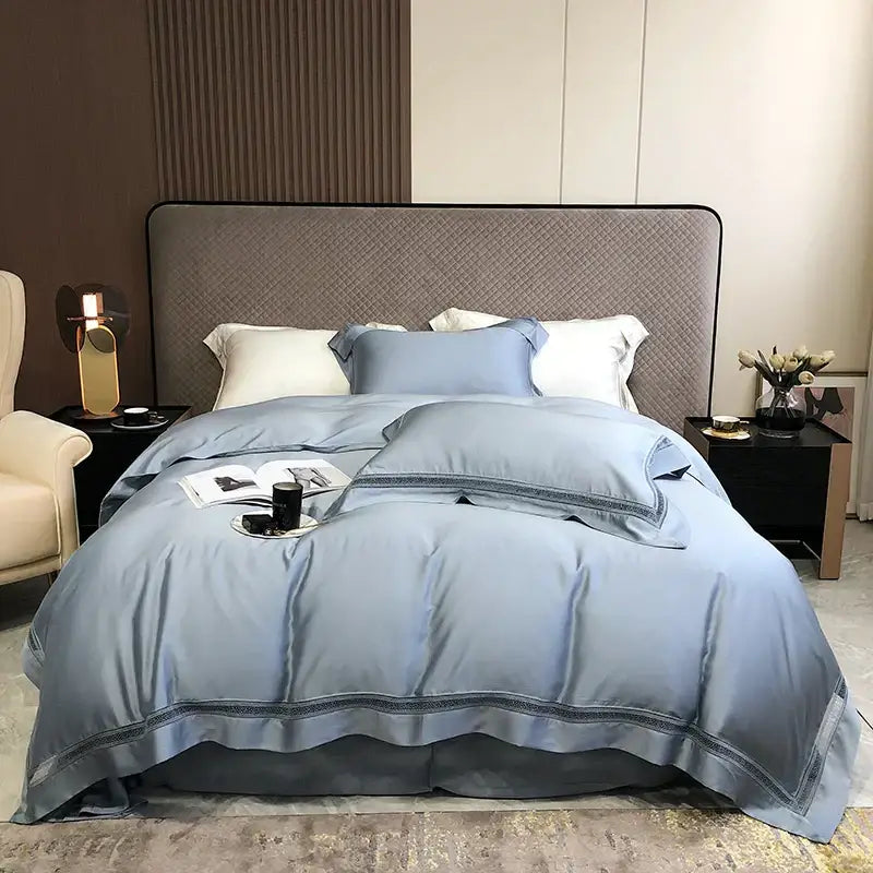 Light blue satin duvet bedding set with subtle embroidered lace trim made from decorbites eucalyptus lyocell luxury fabric