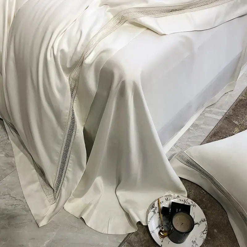 Cream-colored satin bedding set with delicate silver lace trim made from decorbites eucalyptus lyocell luxury fabric