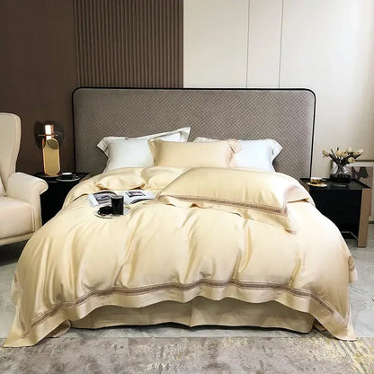 Cream-colored satin bedding set with gold-toned embroidered lace trim made from decorbites eucalyptus lyocell luxury fabric