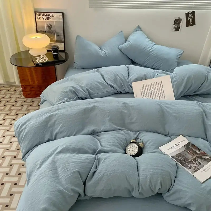Soft blue quilted cotton bedding set with matching pillows featuring a cozy textured fabric finish for bedroom use