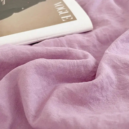 Soft lavender-colored linen fabric with subtle texture in lavender and black cotton bedding set for bedroom use