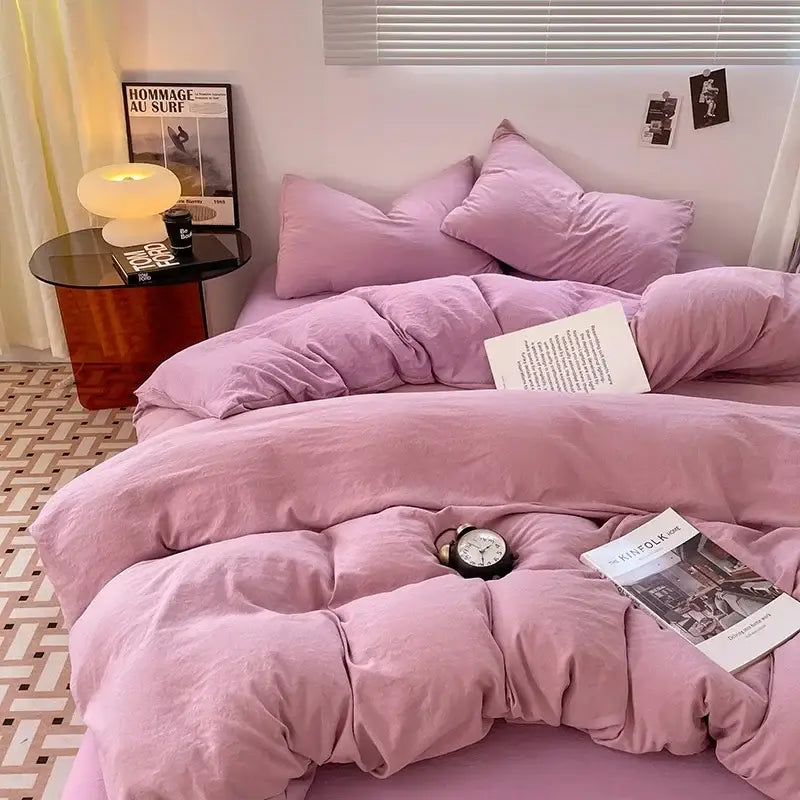 Pink quilted duvet set with soft plush fabric and matching pillows in lavender and black cotton bedding set