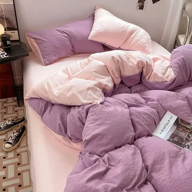 Lavender and black cotton bedding set featuring a purple and pink two-tone quilted duvet with soft textured fabric finish