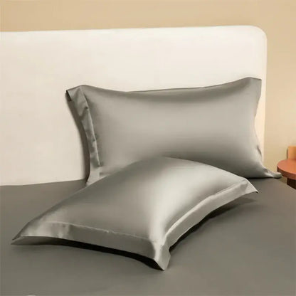 Two sleek silver-gray satin egyptian cotton pillowcases from a lavender cotton pillowcase set for bedroom bedding covers