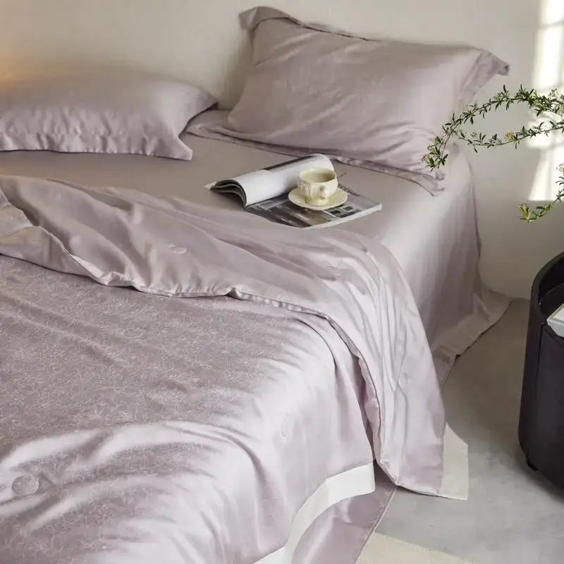 Lavender jacquard quilt set featuring light luxury decorbites satin bedding with floral embroidery and white piping edges