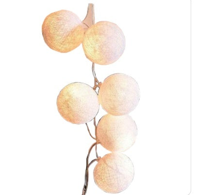 Peach-colored LED cotton ball lights garland with rose gold wire made of cotton balls for decorative lighting