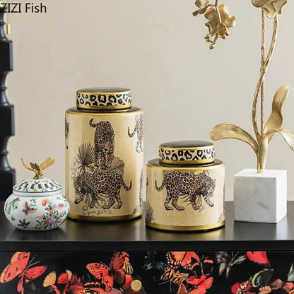 Cream-colored ceramic storage jar with gold trim and decorbites leopard pattern featuring a matching lid