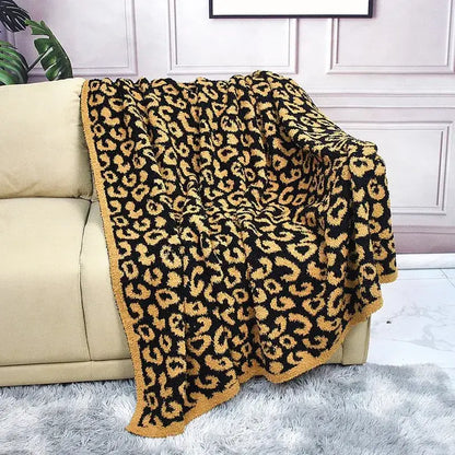 A plush black and gold leopard print cozy flannel velvet throw blanket with soft fuzzy texture for bedroom sofa decorbites