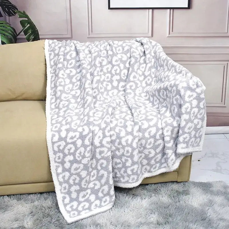 A plush gray and white leopard print cozy flannel velvet blanket with soft fuzzy texture for bedroom sofa decorbites cozy flannel