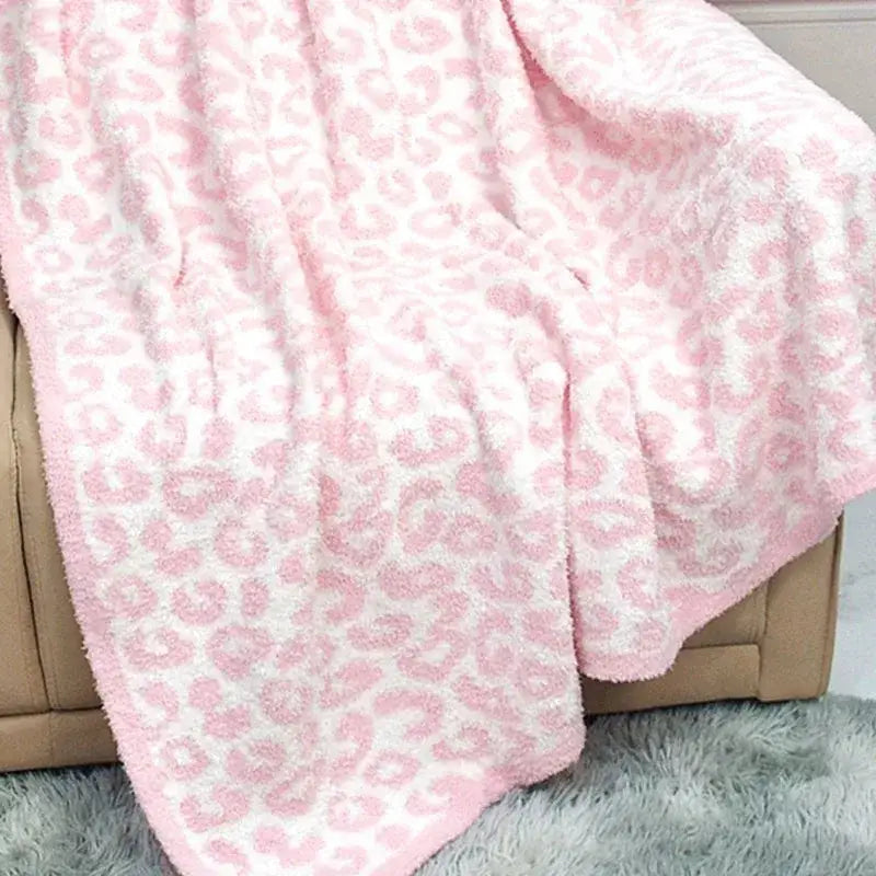 A plush pink and white leopard print cozy flannel velvet blanket with soft texture for bedroom or sofa decorbites decor