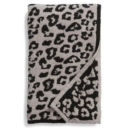 A plush gray and black leopard print fleece blanket with soft textured surface for bedroom sofa decorbites leopard print