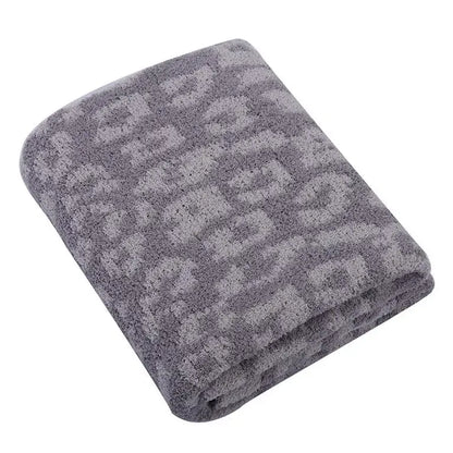 A plush soft gray fleece blanket with subtle texture complements decorbites leopard print sofa throw decor