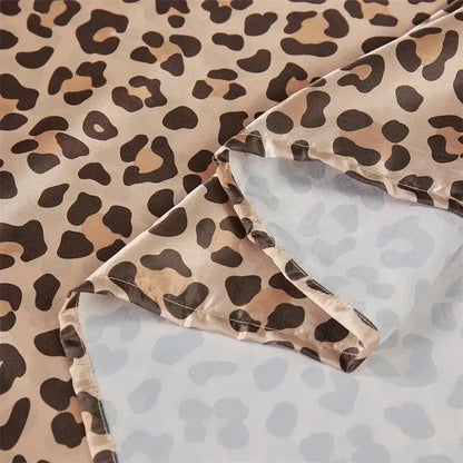 A leopard print satin bedsheet set featuring soft beige and dark brown fabric with a smooth satin finish