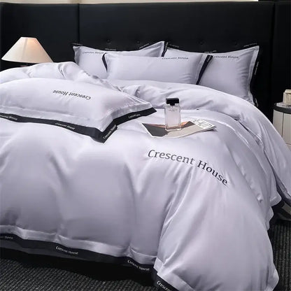 Silver satin duvet cover set with black trim and crescent house branding for decorbites ice silk bed set