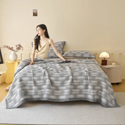 Gray and white striped decorbites cotton towel blanket with a soft textured weave for summer cool quilt use