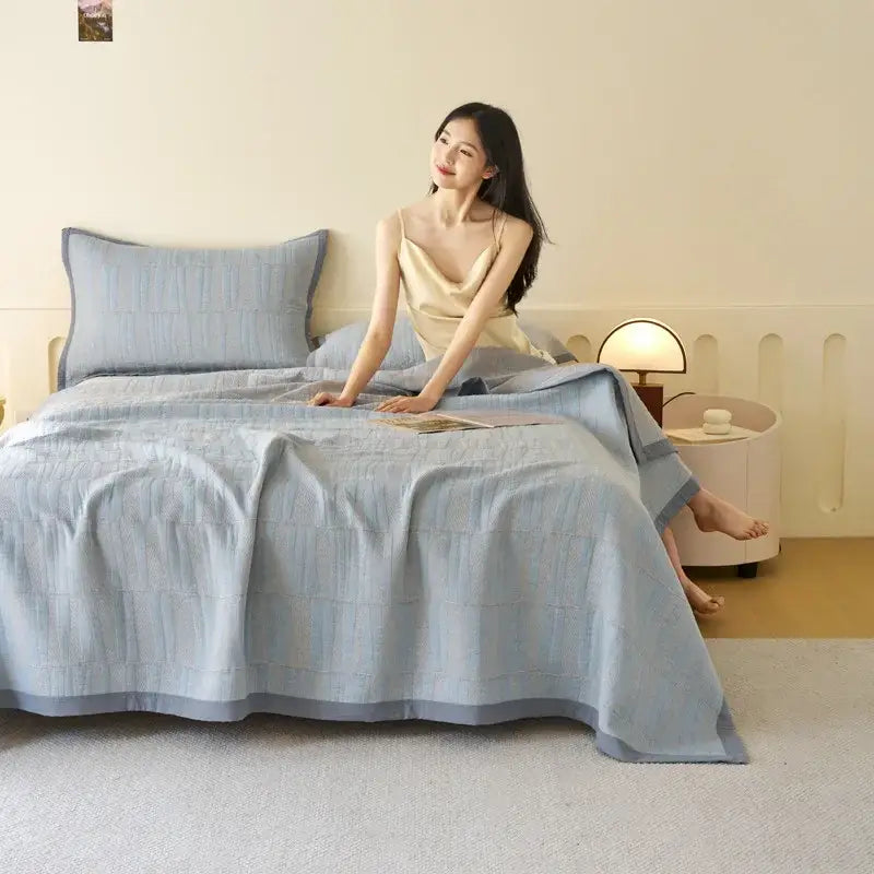 Light blue and gray decorbites cotton summer cool quilt with textured grid pattern and matching towel blanket pillowcases