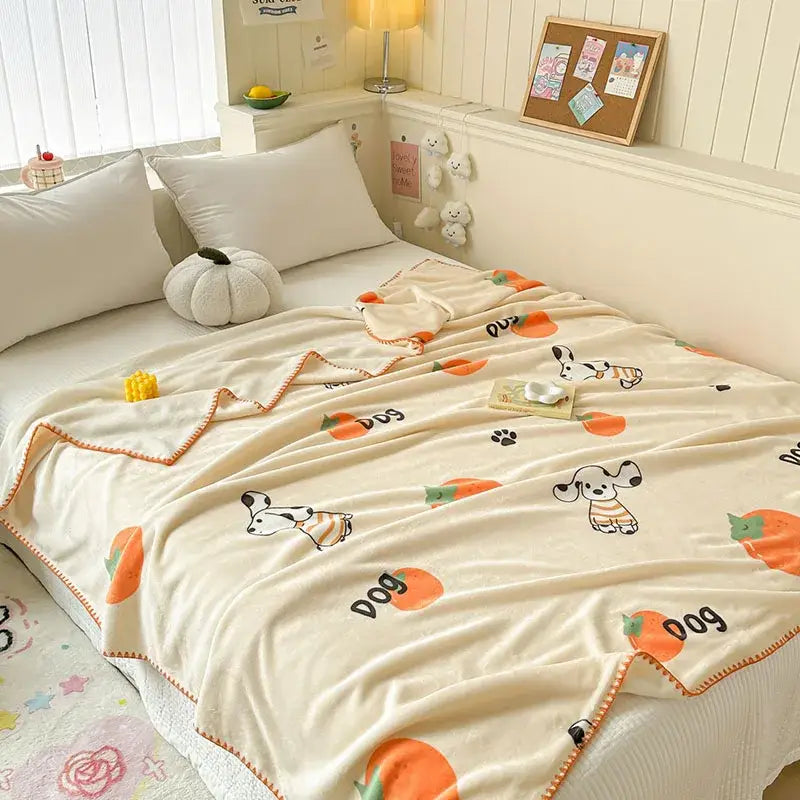 Cream-colored milk velvet blanket with playful dogs pumpkins and orange stitched border from decorbites cozy milk collection