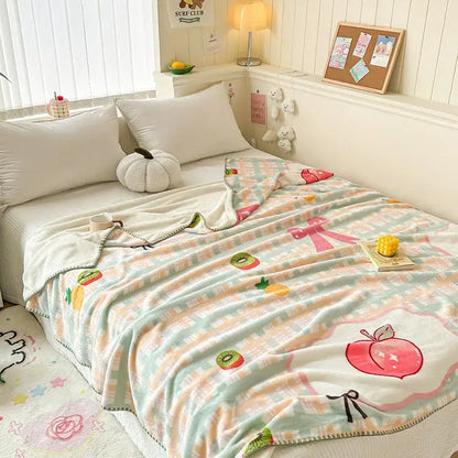 Pastel-colored cozy milk velvet blanket with fruit and bow pattern in mint green peach and white for decorbites cozy milk