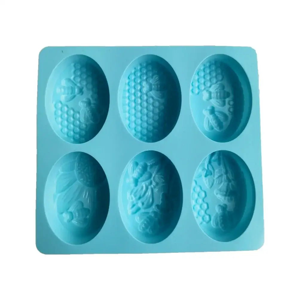 Light blue bee silicone soap mold with six oval cavities featuring intricate honeycomb designs for baking or soap use