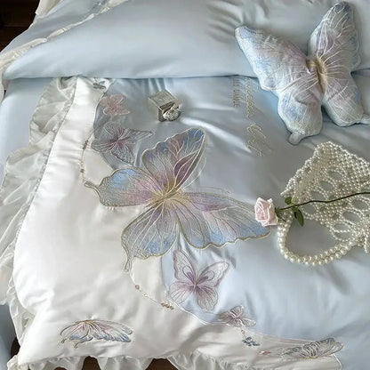Light blue satin bedding set with delicate butterfly embroidery and ruffled edges featuring decorbites french lace