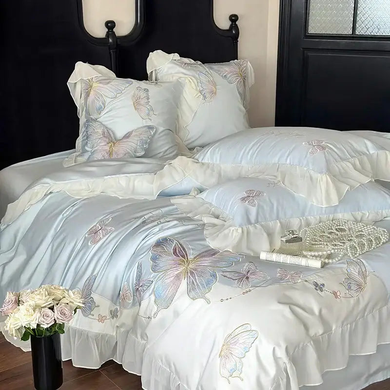 Light blue satin bedding set with delicate butterfly embroidery and soft ruffled edges by decorbites french lace