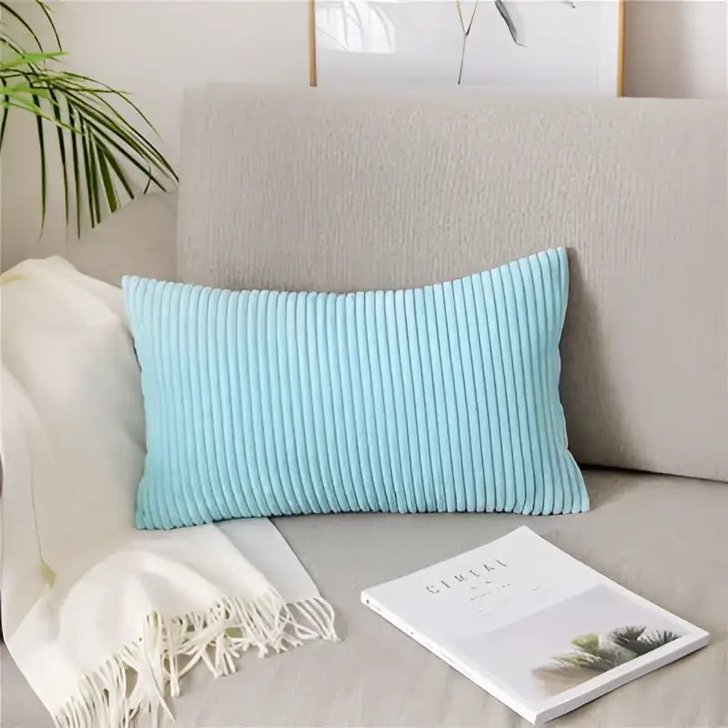 Light blue corduroy flocking pillow cover resting on a beige sofa perfect for living room decor by decorbites corduroy flocking