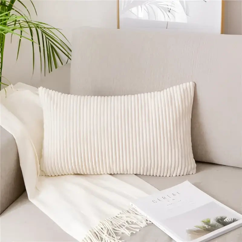 Cream-colored ribbed corduroy rectangular pillow on light gray sofa featuring decorbites corduroy flocking pillow cover