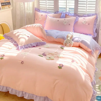 Pastel pink and lavender cotton bedding set with decorbites cartoon embroidery featuring floral and bunny motifs