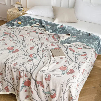 A cream fleece blanket with red and gray birds and pink berries pattern, ideal as a decorbites cotton gauze summer blanket