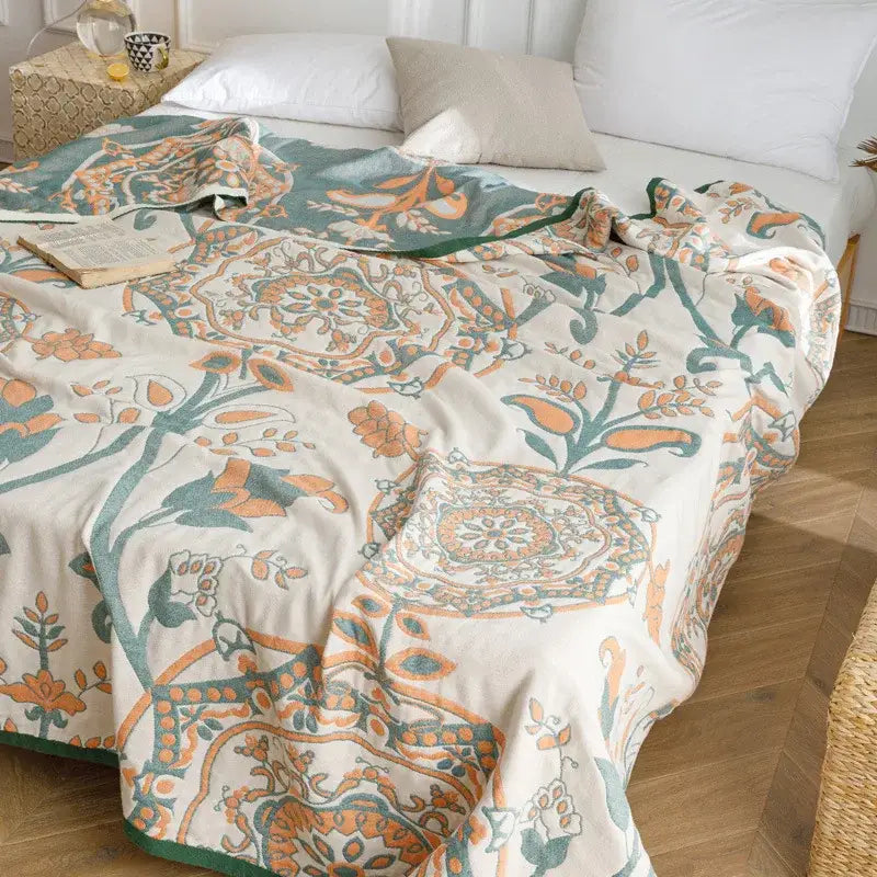 Light blue and gray patterned cotton gauze summer blanket with cream floral mandala design and green border decorbites cotton gauze