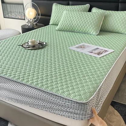 Light green hexagonal quilted mattress pad with white border in a light blue hexagonal ice silk cooling bed mat set