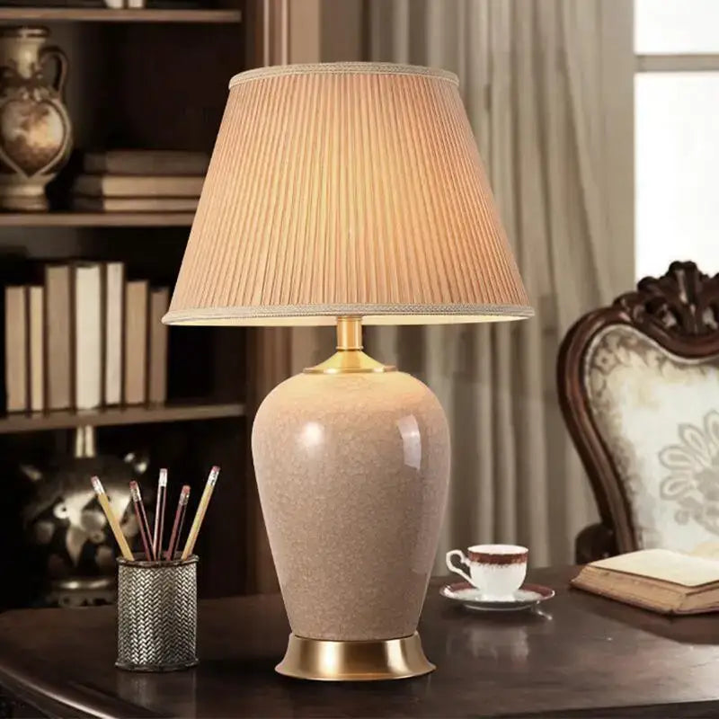 Beige ceramic table lamp with gold-toned metal base and pleated fabric shade from decorbites ice crack ceramic collection